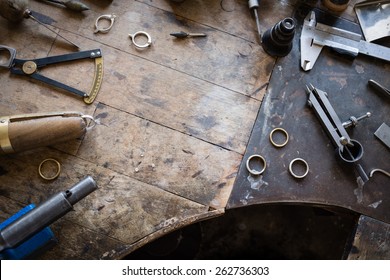 Working desk for craft jewelery making with professional tools. Grunge wooden table. View from above. Copy space. - Powered by Shutterstock