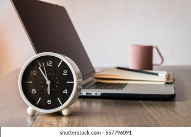 Working Desk, Office And Home Office Concept. With Laptop, Pencil, Clock, Milk Cup On Wooden Table.