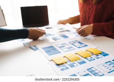 Working at desk, start up, UX team works from a single location under a UX leader and UX managers, UX design involves a great amount of teamwork. - Shutterstock ID 2231296305