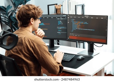Working IT developer with stressful overworked in creating online software development coding on pc screen, thinking program for latest version application on website project at modern office. Gusher.