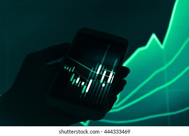 Working with digital tablet computer and smart phone with digital business strategy layer effect and the digital chart. Green Tone.