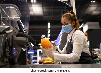 Working During Corona Virus Pandemic. Cashier In Grocery Store Wearing Mask And Gloves Fully Protected Against The Virus.