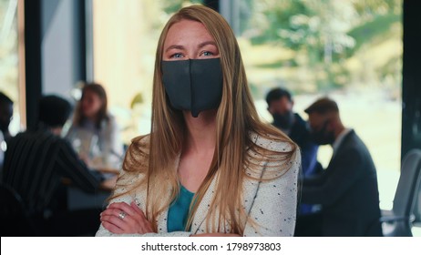 Working During COVID-19 Pandemic. Portrait Of Young Blonde Business Woman Wearing Face Mask At Light Office Slow Motion.