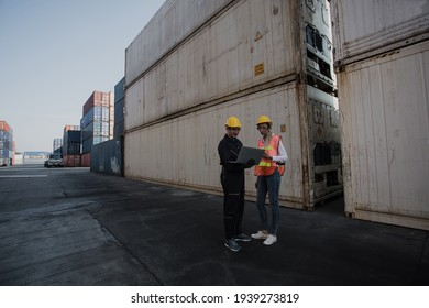 working engineer in the construction container yard.  worker and supervisor checking containers data. Container Shipping Logistics Engineering concept