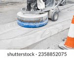 Working Grinding machine polishing a Concrete surface of a city road