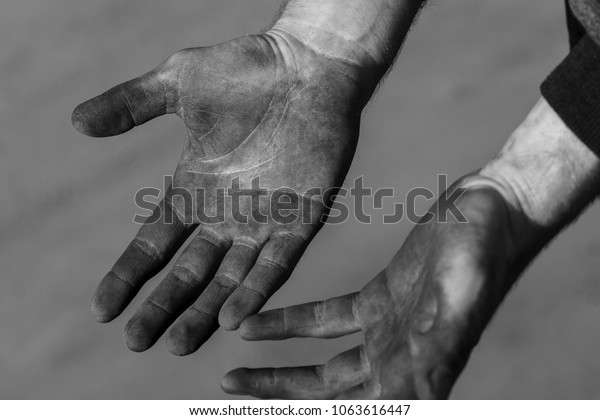 Working hands in mud, soot, dust, oil. An\
experienced car service master. Can be used as a background for an\
inscription, cover or part of a\
design.