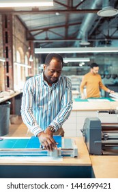 Working Hard. African-American Bearded Worker Of Spacious Publishing Office Working Hard