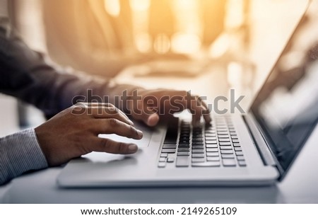 Working hard to increase efficiency and gain a competitive advantage. Closeup shot of an unidentifiable businessman working on a laptop in an office.