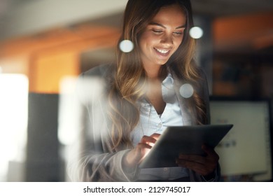 Working hard no matter the time. Shot of a young attractive businesswoman working late at night in a modern office. - Shutterstock ID 2129745017