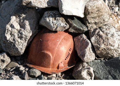 Working Helmet On A Pile Of Stones. The Incident In The Mining Industry Or The Accident Happened