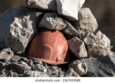 Working Helmet On A Pile Of Stones. The Incident In The Mining Industry Or The Accident Happened