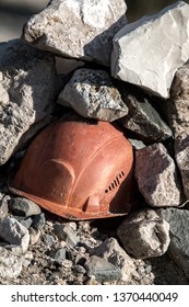 Working Helmet On A Pile Of Stones. The Incident In The Mining Industry Or The Accident Happened