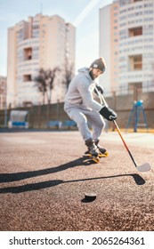 Working with a hockey stick and puck outside the ice on inline skates - rubber coating outdoors for hockey training