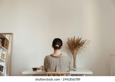 Working at home concept. Girl working at home. Modern home living room interior design. Girl boss, lady boss.
Aesthetic minimalist workspace background. Blog, social media, web, magazine template.