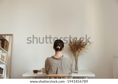 Working at home concept. Girl working at home. Modern home living room interior design. Girl boss, lady boss.
Aesthetic minimalist workspace background. Blog, social media, web, magazine template.