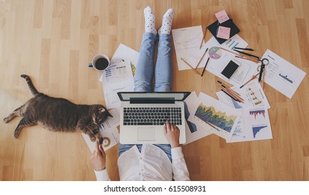 Working home concept - girl with smart phone, laptop and business reports. - Shutterstock ID 615508931