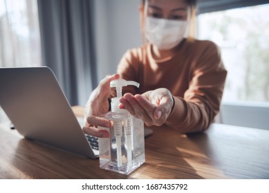 Working from home, Corona virus protection, Closeup cleaning her hands with sanitizer gels, Woman in quarantine for coronavirus wearing protective mask.