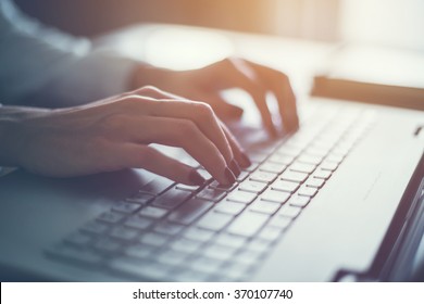 Working at home with laptop woman writing a blog. Female hands on the keyboard - Shutterstock ID 370107740