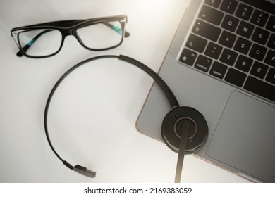 Working From Home Made Easier. Aerial Shot Of A Laptop And Headset On A Table In An Office At Work.