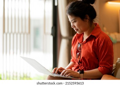 Working At Home Relax Casual Using Laptop In Living Room,asian Female Adult Hand Typing Search Or Texting Via Laptop Working From Home With Happiness Peaceful Smiling Ideas Concept