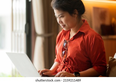 Working At Home Relax Casual Using Laptop In Living Room,asian Female Adult Hand Typing Search Or Texting Via Laptop Working From Home With Happiness Peaceful Smiling Ideas Concept