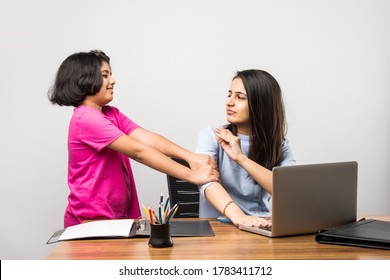 Working Indian Mom Works From Home Office With Kid in Pandemic. Woman And Cute Child Using Laptop. Freelancer Workplace In Cozy Home. Happy Mother And Daughter.