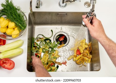 Working kitchen disposer on a modern sink to remove food waste - Powered by Shutterstock