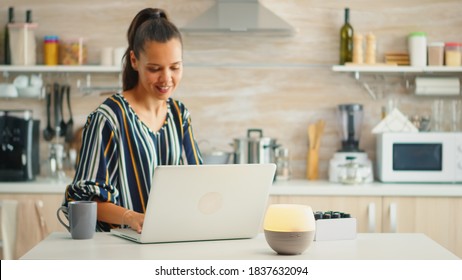 Working in the kitchen with essential oils diffuser steaming. Aroma health essence, welness aromatherapy home spa fragrance tranquil theraphy, therapeutic steam, mental health treatment