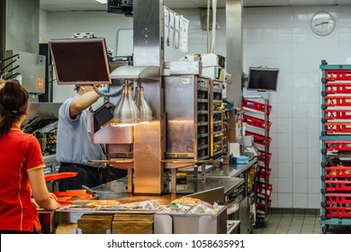 Working In Kitchen Of Modern Fast Food Restaurant.