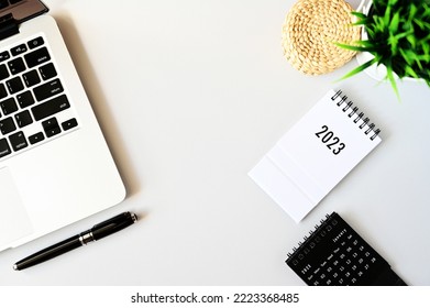 Working with Laptop computer,Smartphone calendar 2023 and cactus copy space on modern table background.Top view,Flat lay,style Minmal workspace,business Concept - Shutterstock ID 2223368485
