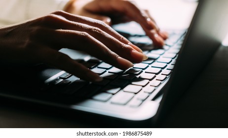 Working Laptop. Freelance Woman. Remote Job. Digital Technology. Unrecognizable Lady Typing Portable Computer In Table Lamp Light Dark Shadow.