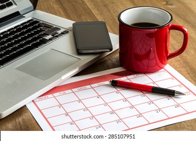 Working with the laptop and organizing monthly activities and appointments in the calendar