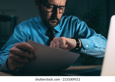 Working Late Night Shift, Businessman In Dark Office Interior Looking At His Wristwatch, Selective Focus