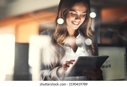 Working late, overtime and dedication with a happy, positive and motivated business woman working on a tablet in her office. Young female executive smiling while feeling dedicated and determined - Powered by Shutterstock