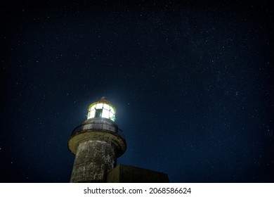 Working lighthouse and starry sky