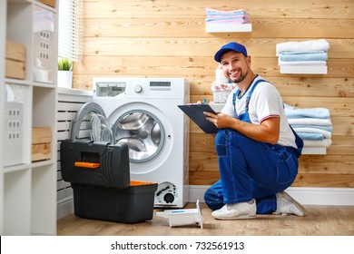 working man plumber repairs a washing machine in   laundry - Shutterstock ID 732561913