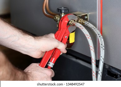 Working Man Is Repairing A Oil Valve In Heating Room