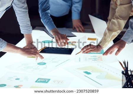 Working meeting in office. Team of Engineers, Scientists and Developers gathered around illuminated conference table. Inspecting industrial market. Concept of teamwork, startup project, career, ad