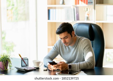 Working Men Using Mobile Phone. Caucasian Man Working On A Computer Desk In A Home Office.