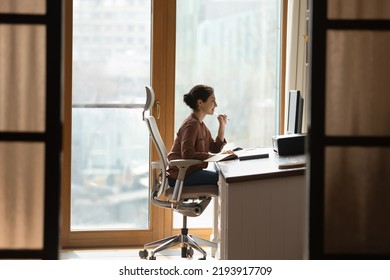 Working at modern home office. Young female architect interior designer sit at desk on ergonomic chair doing job project on desktop pc. Millennial indian woman study at domestic workplace - Shutterstock ID 2193917709