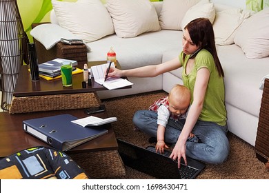 Working mom with baby in her chaotic home office - Shutterstock ID 1698430471