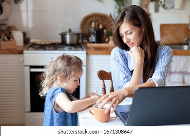 Working Mom Works From Home Office With Kid. Woman And Cute Child Using Laptop. Freelancer Workplace In Cozy Kitchen. Happy Mother And Daughter. Female Business, Empathy, Care. Lifestyle Family Moment