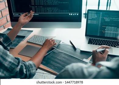 Working in the morning with businessmen are dipping coffee that works with software developers to analysis together the code written in the program on the computer. - Shutterstock ID 1447718978