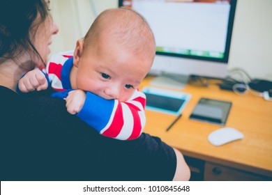 Working Mother With A Baby And Her Computer
