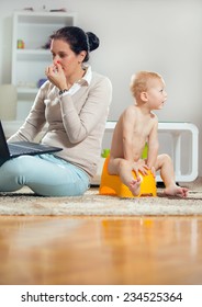 Working Mother Working At Home And Not Watching His Child To The Potty