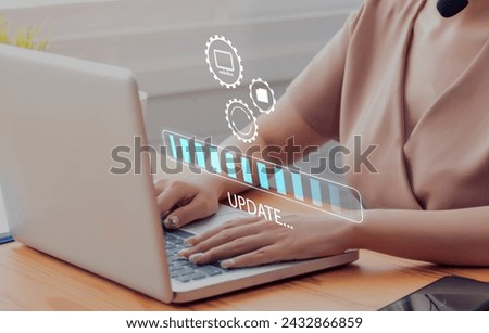 Working in office desktop Installing update system software for device operating systems to be up to date with the new version. Graphics icon showing updating function screen loading on laptop.