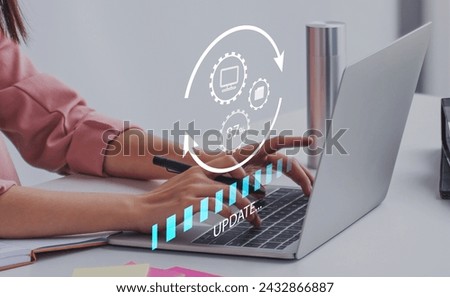 Working in office desktop Installing update system software for device operating systems to be up to date with the new version. Graphics icon showing updating function screen loading on laptop.