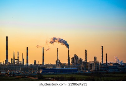 Working Oil Refinery. Smoke From The Factory Chimney. Ecological Pollution. Air Emissions Polluting The City. Industrial Waste Is Hazardous To Health. Large Factory In Smog, Production In Operation.