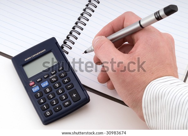 Working on business,\
with pen and calculator