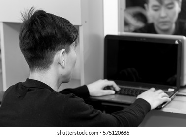 working on the computer young man